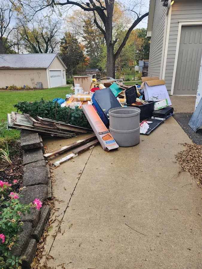 Dumpster being loaded with debris for Roofing Dumpster Rental in Sauk Village